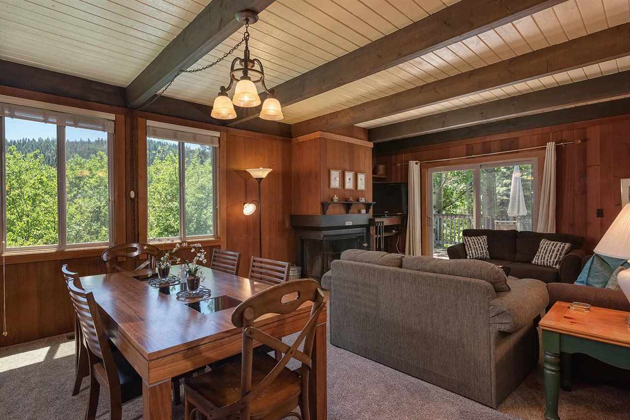 Dining room with seating for eight under vaulted wood-beam ceilings — perfect for group dinners after skiing Palisades Tahoe