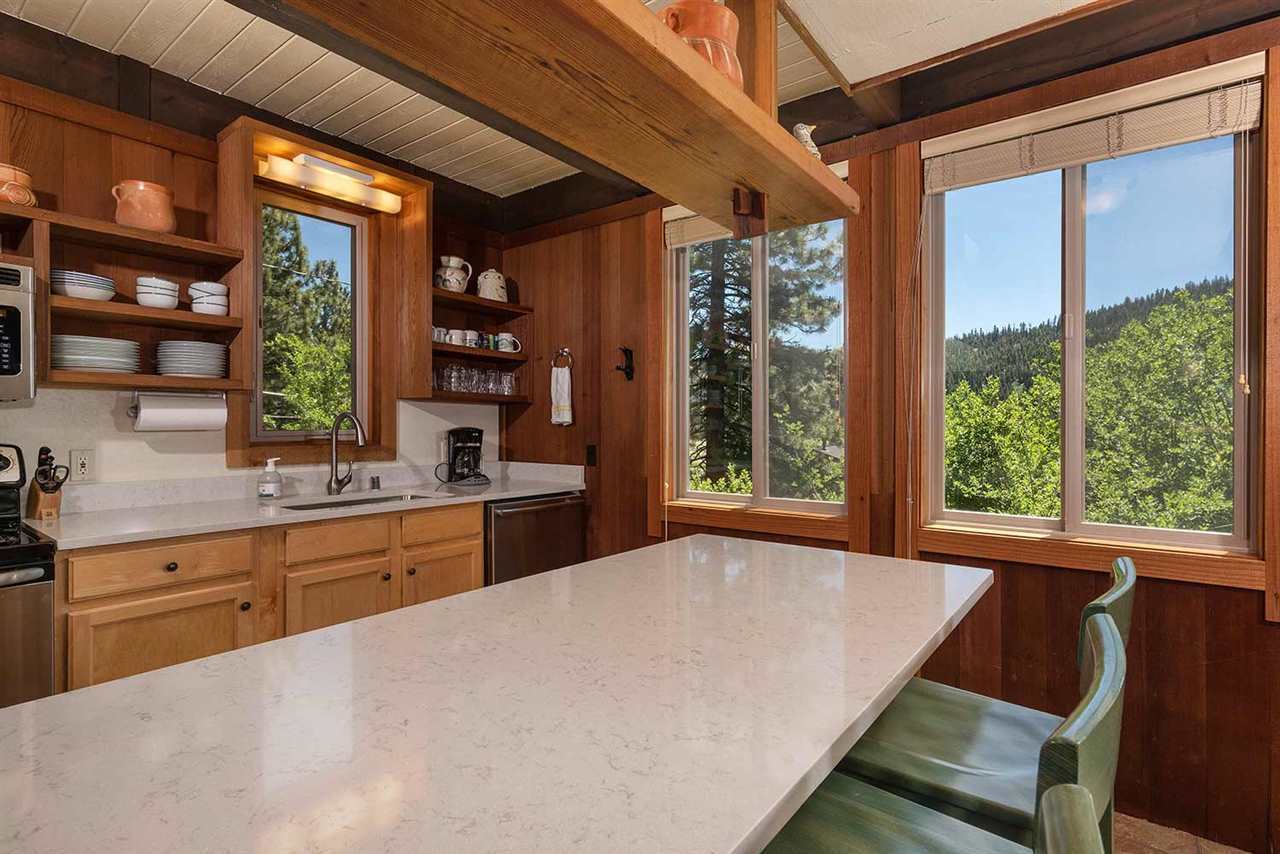 Chef's kitchen with granite breakfast bar and stainless steel appliances in the Lake Tahoe rental cabin